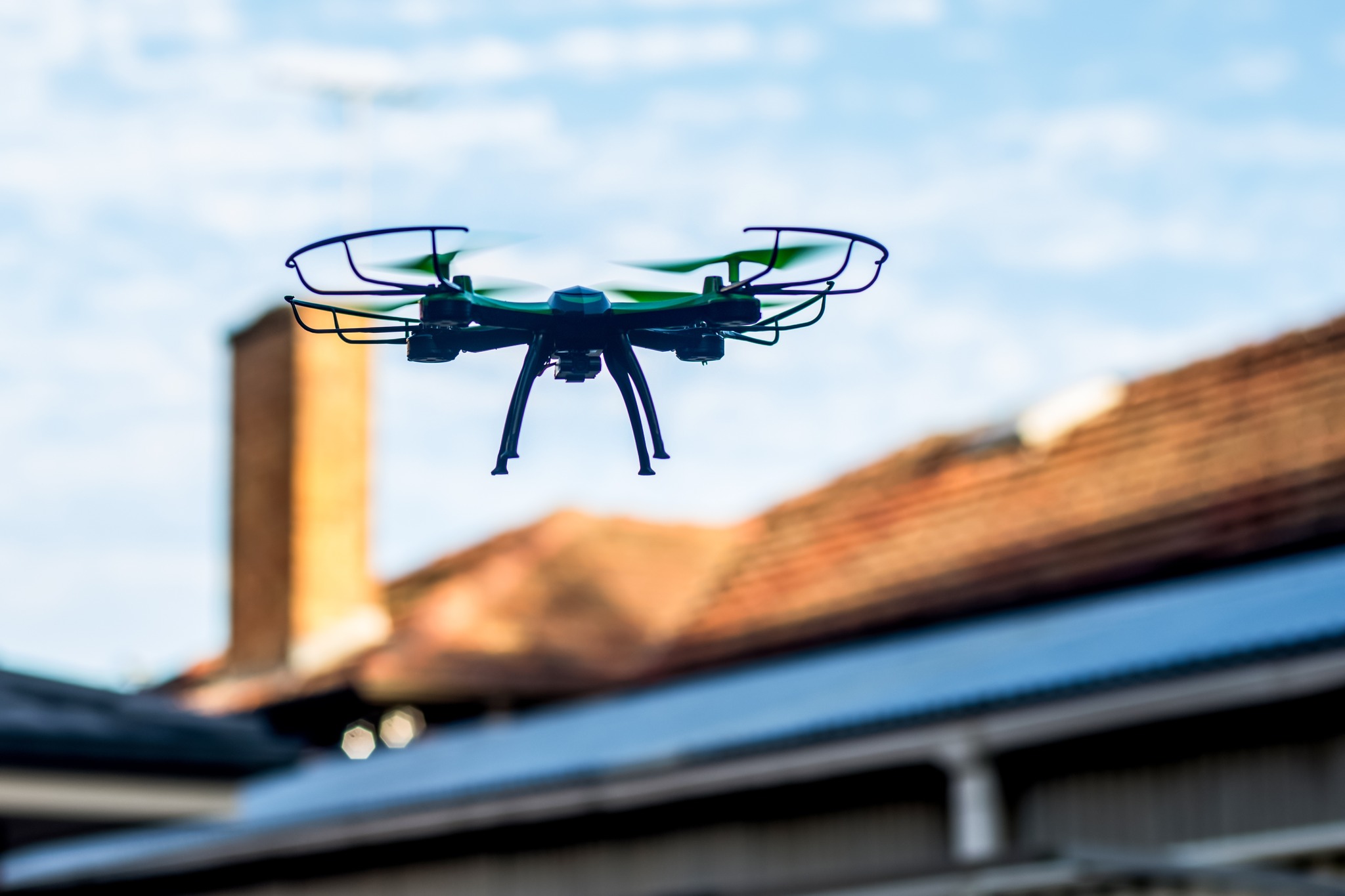 Drone performing roofing survey Drone performing roofing survey